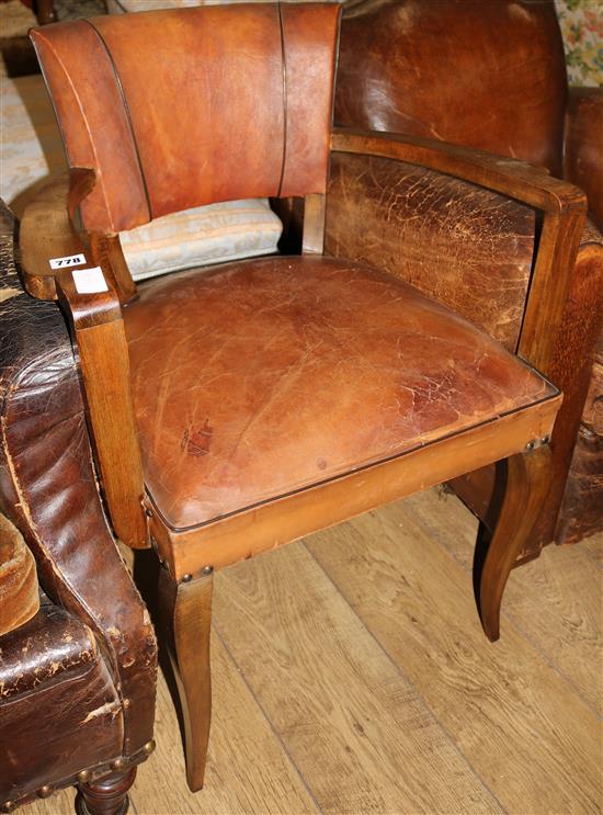 A 1920s French beech and tan leather elbow chair